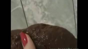 Spunky dark-haired girl peeing and crapping in the bathtub